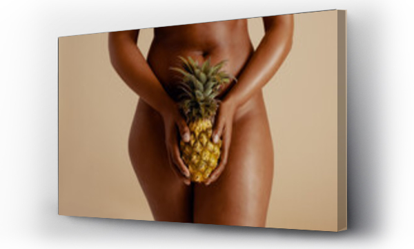 Wizualizacja Obrazu : #691472200 Empowering female wellness: Sensual woman holding a pineapple in a studio