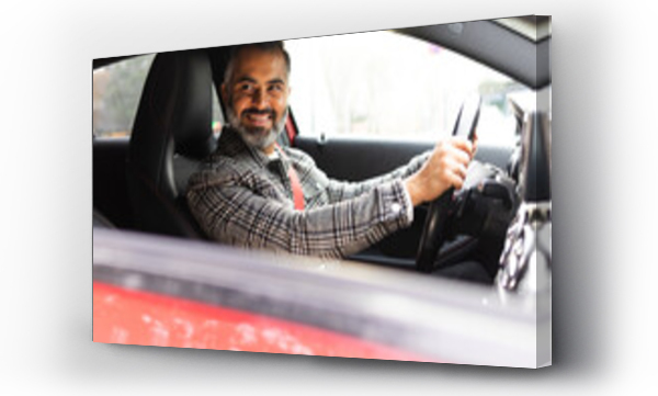 Wizualizacja Obrazu : #695414633 Smiling Indian man driving car while looking away