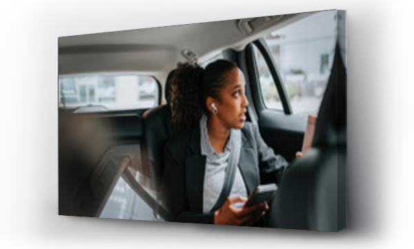 Wizualizacja Obrazu : #697229549 Businesswoman looking through window and talking on smart phone while sitting in car