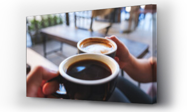Wizualizacja Obrazu : #703360244 Closeup image of a couple people clinking coffee mugs in cafe