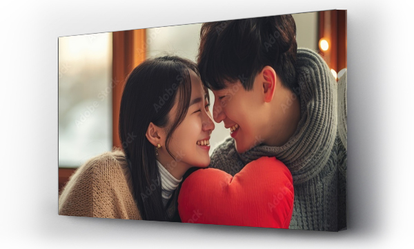 Wizualizacja Obrazu : #709299299 Asian couple surprised each other on Valentines Day with a small red heart-shaped pillow.