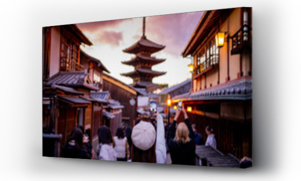 Wizualizacja Obrazu : #724315159 Yasaka Pagoda view and Hokan-ji Temple from Yasaka Dori street in Kyoto, Japan. Popular touristic street leading to Kyomizu Dera,Young female tourist taking photo with a mobile phone during sunset.