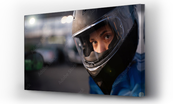 Wizualizacja Obrazu : #748092967 female motorcyclist close-up in a helmet in the evening on a motorcycle in the city.