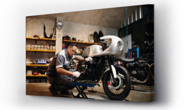 Wizualizacja Obrazu : #755431079 Repairman choosing tool when fixing motorcycle in his repairshop