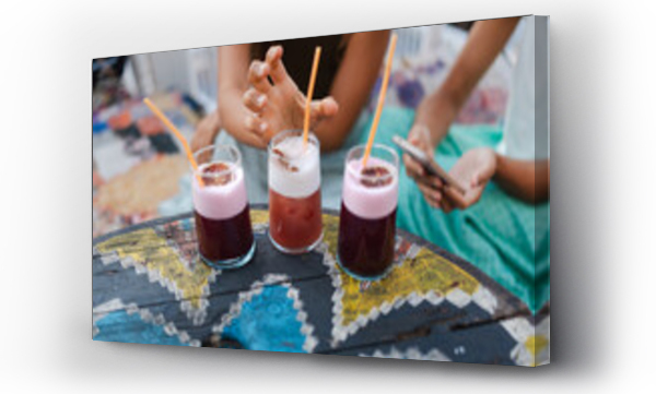 Wizualizacja Obrazu : #759144876 Blended strawberry smoothie in a glass, held by a womans hand.