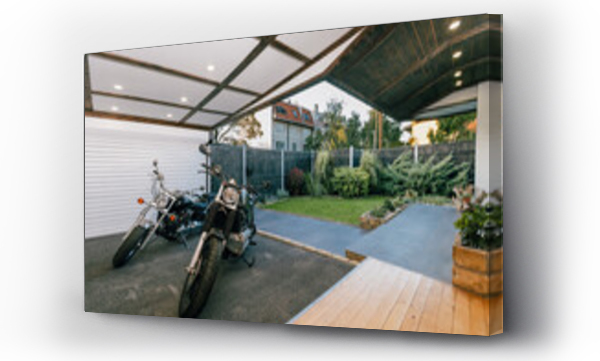 Wizualizacja Obrazu : #759160467 Motorbikes parked in an open garage in a landscaped house backyard
