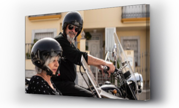 Wizualizacja Obrazu : #763312182 a mature senior couple aged 60 or older prepare for a sidecar ride