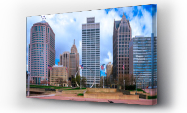 Wizualizacja Obrazu : #778838787 Detroit City vibrant skyline, high-rising buildings, modern plaza park with American Flags waving under dramatic white clouds in the blue sky in Michigan, USA